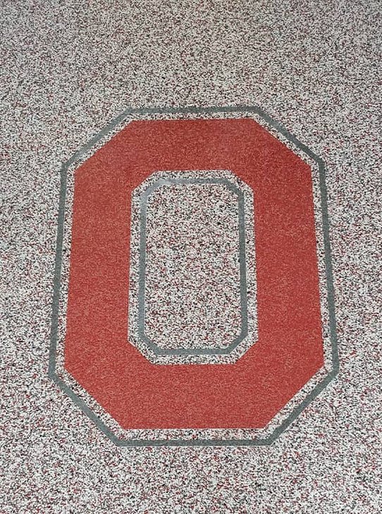 Ohio State block O in a red, gray, and white flake epoxy floor